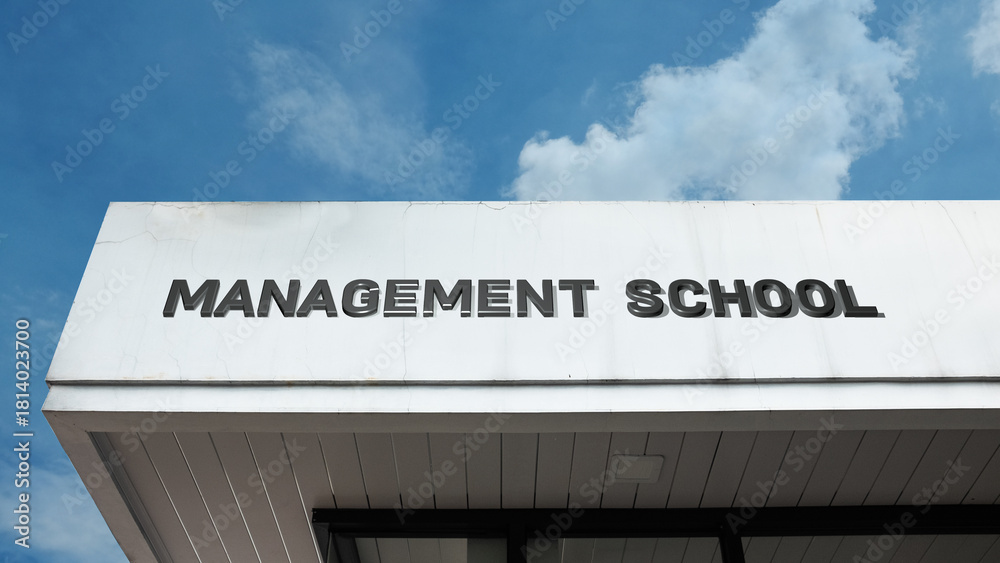 Fototapeta premium Management School sign on a building against a clear blue sky, symbolizing business education, leadership training, professional development, corporate strategy, and higher ed