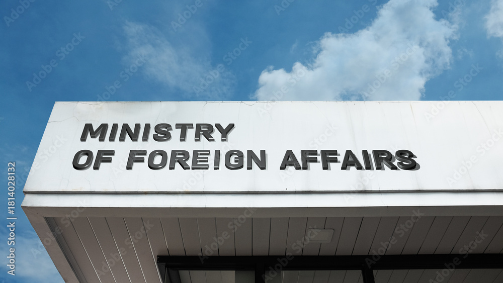 Obraz premium Ministry of Foreign Affairs sign on a building against a clear blue sky, symbolizing international relations, diplomacy, national policy, global affairs, representation, and authority
