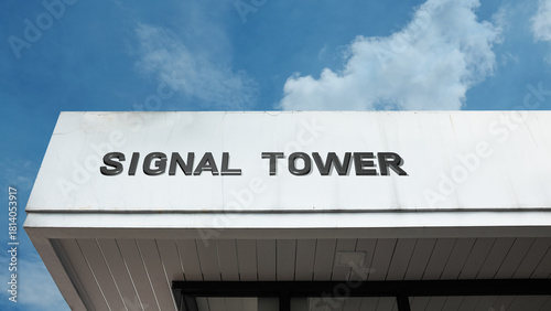 Signal Tower word signage on a communications or broadcasting building under a blue sky, symbolizing connectivity, telecommunications, wireless network, digital infrastructure, and radio frequency