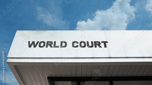 World Court sign displayed on its building facade against a clear blue sky, symbolizing international justice, global law, legal arbitration, human rights, and peaceful dispute resolution