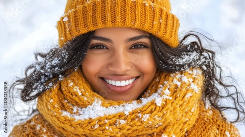 A beautiful woman with dark curly hair smiles brightly in winter