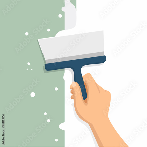 Ambiance bricolage, gros plan sur une main qui étale de l'enduit sur un mur avec une spatule, ou taloche, rénovation, travaux