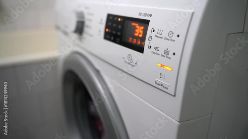 Working washing machine close up shot with digital control panel.