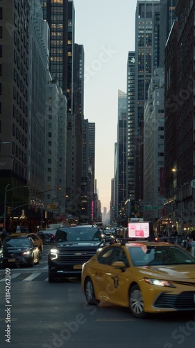 Busy New York City Streets at Late Afternoon, Featuring Iconic Yellow Taxis and Modern Skyscrapers
