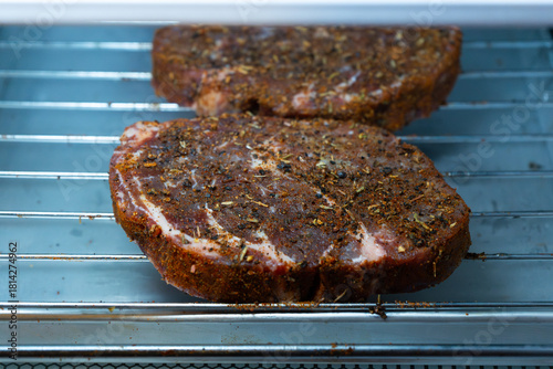 Photography Raw ribeye steak dry brine with salt, bell pepper, and aromatic herbs rub, place