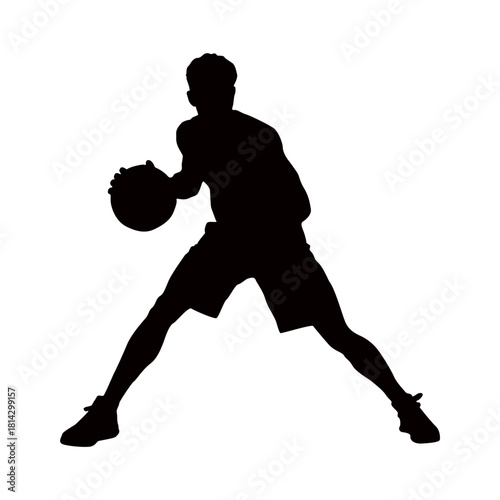 Silhouette of a basketball player dribbling the ball with focus and determination