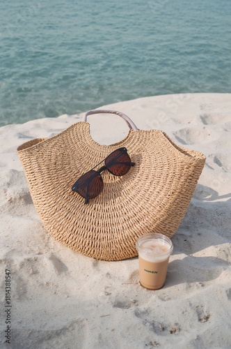 Enjoying a Refreshing Drink by the Beach With Sunglasses and a Stylish Bag