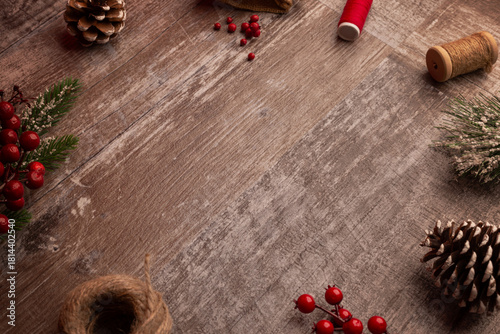 Festive Christmas background with rustic wood surface, seasonal greenery, pinecones and berries arranged for holiday promotions, winter campaigns, greetings and product placement