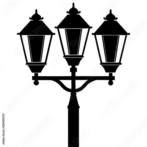 An old vintage metal street lamp on a tall iron post illuminates the dark city sky