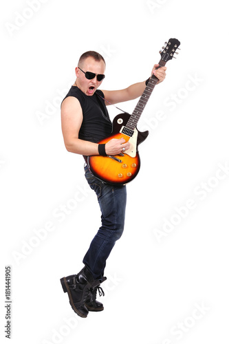 Rock man and roller expressively plays the guitar with it raised up