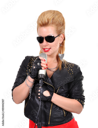 A rocker girl in a leather jacket with microphone.