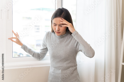 Young Asian females feeling dizzy after standing too fast, have symptoms of low blood pressure