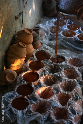 Close-Up of Multiple Jaggery Molds with a Shaft of Light