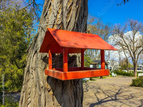 A homemade bird feeder painted red