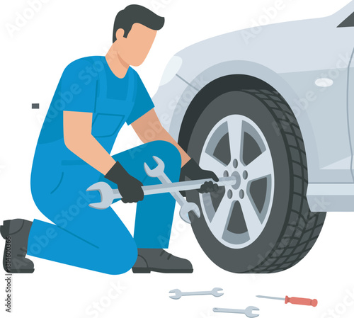 Mechanic in blue overalls working on a car's wheel, using tools.