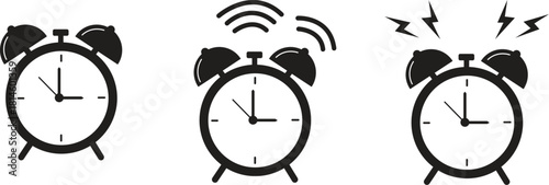 Three alarm clocks in different states of ringing black