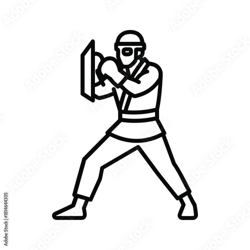 Karate fighter in defensive stance isolated on