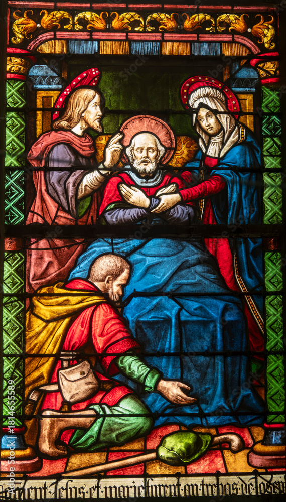 Fototapeta premium Stained glass (16th century) of Death of Saint Joseph surrounded by Mary and Jesus.