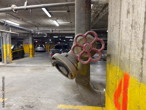 Industrial parking garage with pipe valve in urban setting