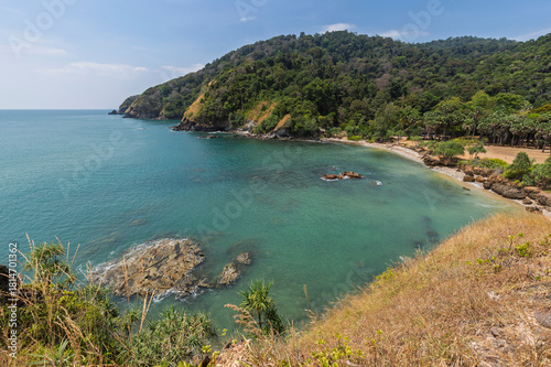 Scenic view of the sea, rocky shoreline and lush nature from above at the Mu Ko Lanta National Park in Koh Lanta, Thailand, on a sunny day.