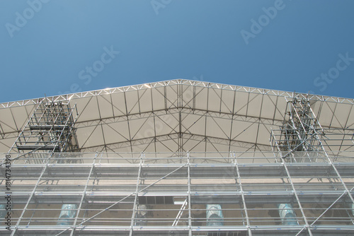Scaffolding on the roof of a construction site to protect workers from the sun's rays and heat, Rome, Italy.