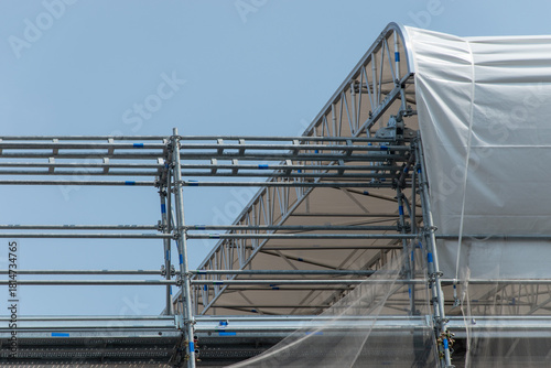 Scaffolding on the roof of a construction site to protect workers from the sun's rays and heat, Rome, Italy.