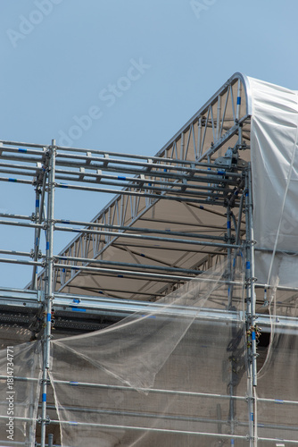 Scaffolding on the roof of a construction site to protect workers from the sun's rays and heat, Rome, Italy.