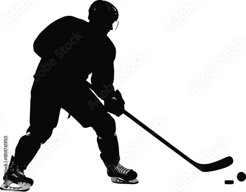 Silhouette of an ice hockey player in action, stickhandling a puck