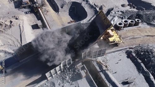 Mining Haul Trucks Dumping Ore into Primary Crusher