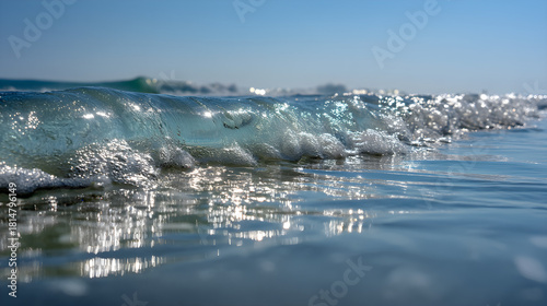 Fototapeta Naklejka Na Ścianę i Meble -  Sparkling ocean wave cresting with sunlight reflecting on the water surface.