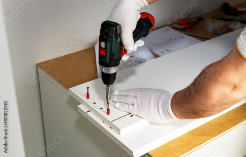 Wallpaper Mural Assembling cabinet furniture with an electric screwdriver Torontodigital.ca
