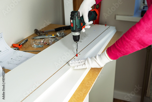 Wallpaper Mural Assembling cabinet furniture with an electric screwdriver Torontodigital.ca