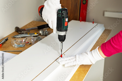 Wallpaper Mural Assembling cabinet furniture with an electric screwdriver Torontodigital.ca