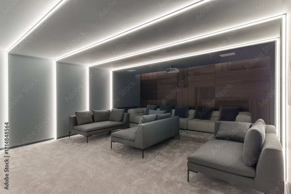 Fototapeta premium This lounge area features contemporary sofas arranged for comfort, accented by ambient lighting along the walls. The stylish decor creates a relaxing atmosphere for social gatherings