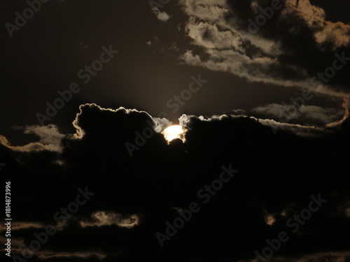 Dramatic storm clouds with bright silver lining backlit by sun