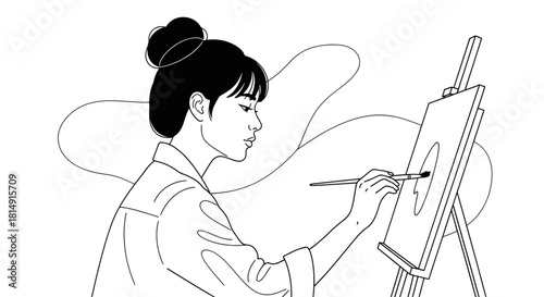 Artist painting on canvas focused and concentrated on her artwork.