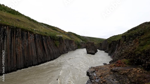 Aerial Stuðlagil Canyon basalt river Iceland
Drone view of the Stuðlagil Canyon with its steep basalt columns rising above the fast-flowing glacial river in Iceland, 2025
