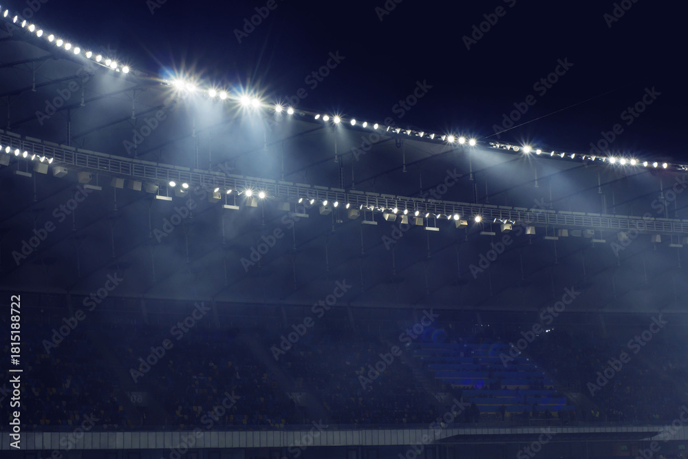 Ταπετσαρία Night football stadium illuminated by powerful floodlights with light smoke and crowd atmosphere in the background
