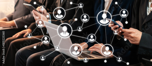 Obraz na plátně Individuals engage in a professional networking event, utilizing smartphones and laptops to foster connections, ideas, and collaboration in a corporate atmosphere