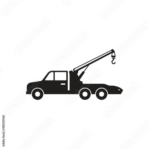 Black silhouette vector illustration of a tow truck viewed from the side against a white background The image is simple and flat in style