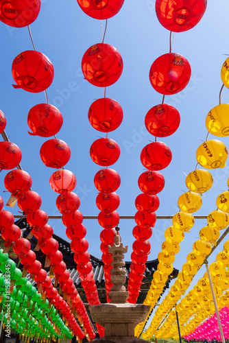 stone pagoda and colorful lotus lanterns hanging in a Buddhist temple