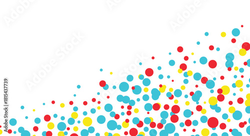 Festive and abstract background with a cascade of colorful red, yellow, and blue dots creating a confetti-like effect.