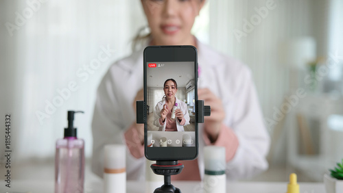 Asia woman people anti aging expert modern health vlogger live advice talk selfie video mobile phone camera. Online digital seller asian small SME store shop owner side hustle filming sell skin care.