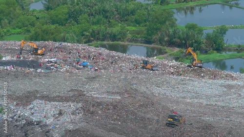  Aerial footage of a landfill in Medan, showcasing heavy machinery managing and organizing waste efficiently