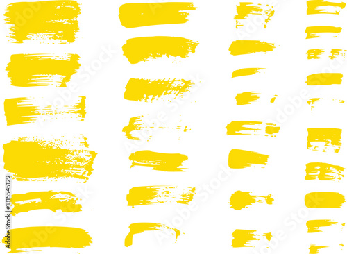 Collection of Yellow Brush Strokes and Paint Splatters on White Background