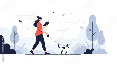 Young woman reads a book while walking her dog on a leash through a serene park with minimalist trees and bushes on a breezy autumn day.