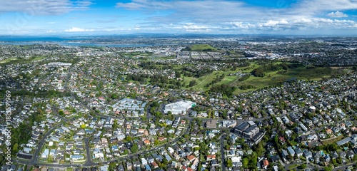 Aerial panorama of Meadowbank, Auckland, New Zealand, showcasing residential areas, golf courses, and the cityscape. The image highlights urban planning and landscape.