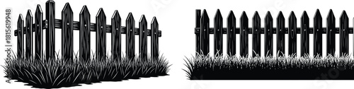 Classic pointed picket fence sections with wooden planks standing firmly in the vibrant green grass