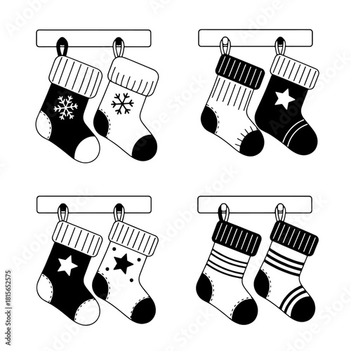 Four pairs of Christmas stockings hanging from a mantelpiece, each pair with different patterns and designs.