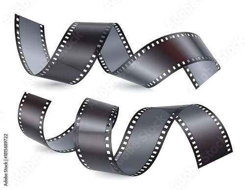 Curled photographic film strips, slightly translucent, against a white background, cast shadow